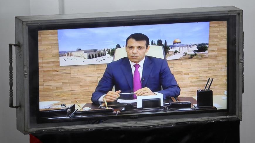 Exiled former senior Fatah member Mohammed Dahlan attends a Palestinian legislative Council meeting in Gaza City through video conference from the United Arab Emirates on July 27, 2017 following developments at the Al-Aqsa Mosque compound.

Palestinians were set to return to pray at a sensitive Jerusalem holy site after Israeli authorities removed controversial new security measures, potentially ending a nearly two-week crisis that sparked deadly unrest. Dahlan, Palestinian president Mahmud Abbas's exiled r