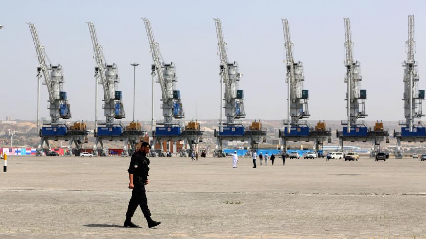 A police officer walks around during an inauguration ceremony of new equipment and infrastructure at Shahid Beheshti Port in the southeastern Iranian coastal city of Chabahar, on the Gulf of Oman, on February 25, 2019. (Photo by ATTA KENARE / AFP)        (Photo credit should read ATTA KENARE/AFP via Getty Images)