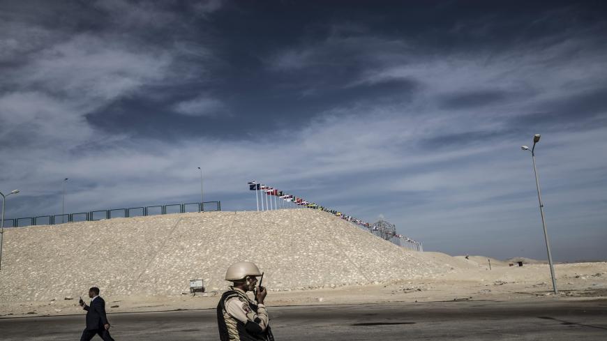 An Egyptian soldier stands guard during an organised tour for diplomats to mark the 150th anniversary of the inauguration of the Suez Canal, in the northeastern city of Ismailia on November 17, 2019. - One hundred and fifty years after the Suez Canal opened, the international waterway is hugely significant to the economy of modern-day Egypt, which nationalised it in 1956. The canal, dug in the 19th century using "rudimentary tools" and which links the Mediterranean to the Red Sea, was opened to navigation i