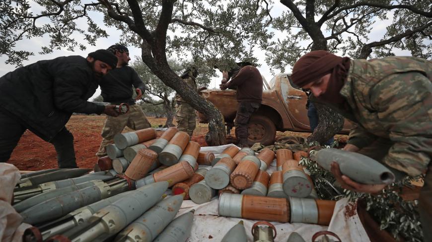 Syrian rebel fighters unload artillery shells amid clashes with government forces in the last major rebel bastion of Idlib in northwestern Syria on February 6, 2020. - Syrian regime forces were locked in clashes with jihadists and allied rebels in a key highway town in northwest Syria, a monitor said, despite Turkey warning pro-government fighters should back off. (Photo by Omar HAJ KADOUR / AFP) (Photo by OMAR HAJ KADOUR/AFP via Getty Images)