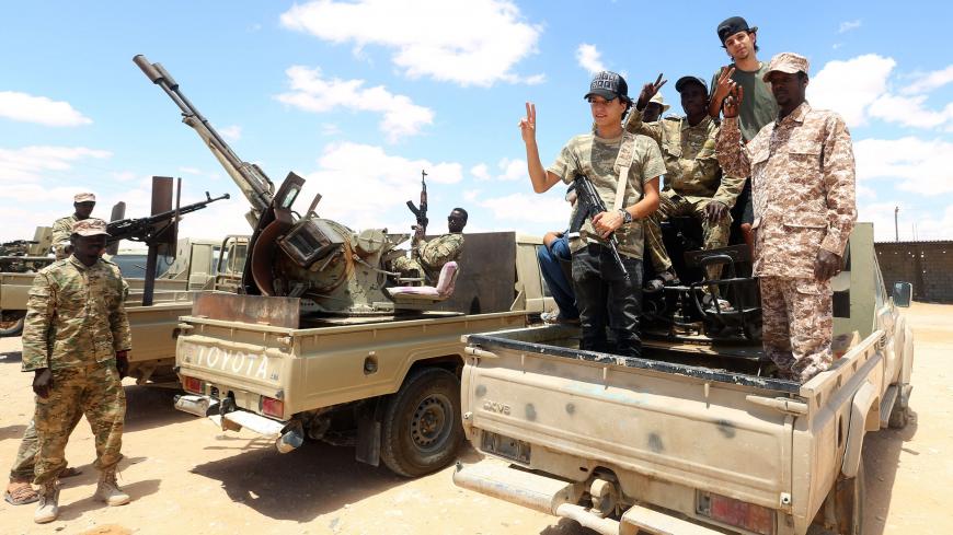 Fighters loyal to the UN-recognised Libyan Government of National Accord (GNA) secure the area of Abu Qurain, half-way between the capital Tripoli and Libya's second city Benghazi, against forces loyal to Khalifa Haftar, who is based in eastern Benghazi, on July 20, 2020. - Since 2015, a power struggle has pitted the (GNA) against forces loyal to Haftar. The strongman is mainly supported by Egypt, the United Arab Emirates and Russia, while Turkey backs the GNA. (Photo by Mahmud TURKIA / AFP) (Photo by MAHMU