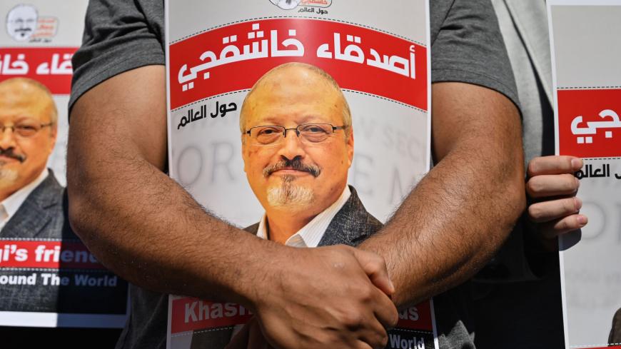 Friends of murdered Saudi journalist Jamal Khashoggi hold posters bearing his picture as they attend an event marking the second-year anniversary of his assassination in front of Saudi Arabia Istanbul Consulate, on October 2, 2020. - Khashoggi, a Washington Post columnist, was killed and dismembered at the Saudi consulate in Istanbul on October 2, 2018, in an operation that reportedly involved 15 agents sent from Riyadh. His remains have not been found. (Photo by Ozan KOSE / AFP) (Photo by OZAN KOSE/AFP via
