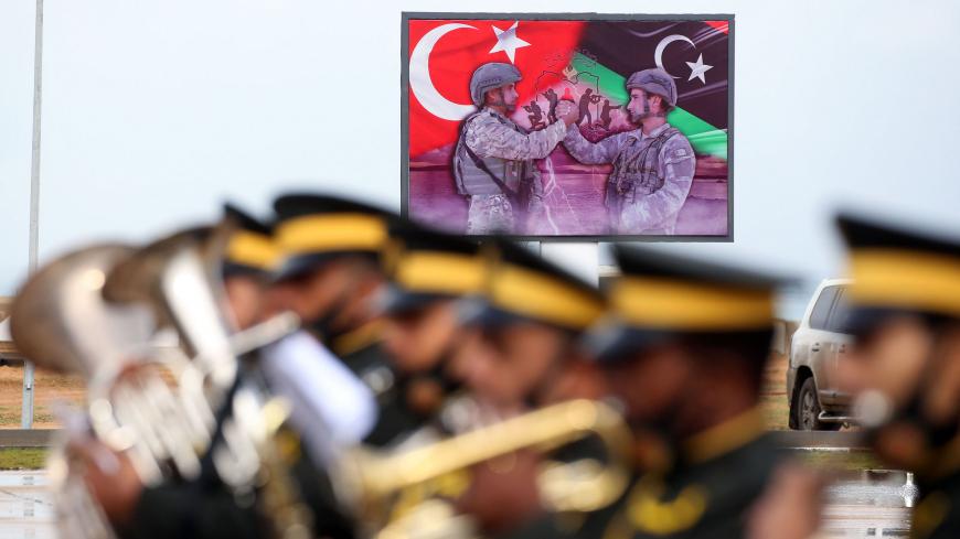 A military band performs during a graduation ceremony of soldiers loyal to Libya's UN-recognised Government of National Accord (GNA), a result of a military training agreement with Turkey, at the Omar Mukhtar camp in the city of Tajoura, southeast of the capital Tripoli on November 21, 2020. (Photo by Mahmud TURKIA / AFP) (Photo by MAHMUD TURKIA/AFP via Getty Images)