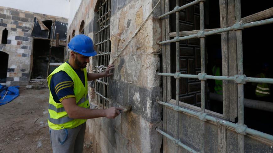 Workers restore a palatial Ottoman-era home called Beit al-Quwatli to turn it into a cultural institution  in the old part of Syria's capital Damascus on November 10, 2020. - The old city of the Syrian capital is famed for its elegant century-old houses, usually two storeys built around a leafy rectangular courtyard with a carved stone fountain at its centre. While the capital has been largely spared the violence of Syria's almost ten-year war, several of these traditional homes have been abandoned by their