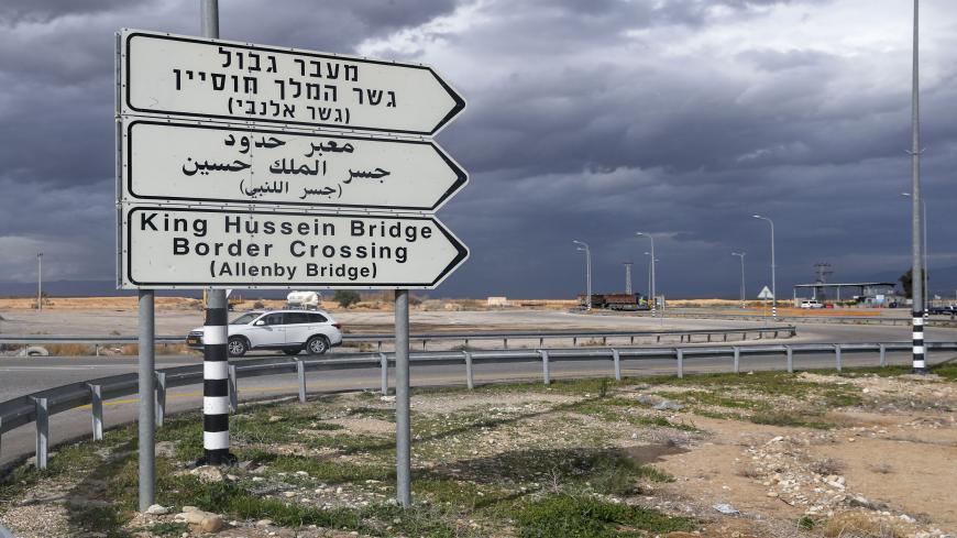 A car drives past a road signal indicating the Allenby crossing point to Jordan (background), in the city of Jericho in the occupied West Bank, on January 28, 2021. - The Allenby (King Hussein) bridge crossing is due to be closed in the evening as part of restrictions to stem the spread of the COVID-19 pandemic. (Photo by AHMAD GHARABLI / AFP) (Photo by AHMAD GHARABLI/AFP via Getty Images)