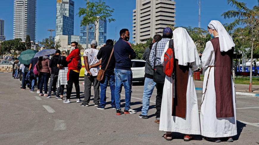 French nuns living in Israel queue with other foreign residents to receive a dose of COVID-19 coronavirus vaccine at the Tel Aviv Sourasky Medical Centre for foreign nationals in the Mediterranean coastal city of Tel Aviv on February 9, 2021 during a campaign to vaccinate foreign workers and refugees against coronavirus. (Photo by JACK GUEZ / AFP) (Photo by JACK GUEZ/AFP via Getty Images)