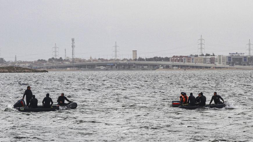 Rescue divers conduct search operations for victims of a capsized boat in Lake Mariout, 20 kilometres (12 miles) west of Egypt's second city of Alexandria on February 23, 2021. - Nine people drowned and at least four were missing after the boat chartered for a family fishing trip capsized. State newspaper Al-Ahram said a six-month-old infant was among the family members drowned. Six survivors are receiving treatment in local hospitals while emergency teams have been sent to the lake to search for the missin