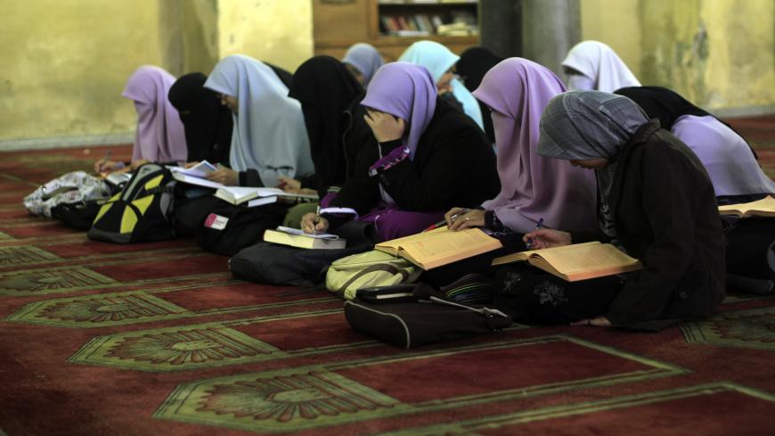 Indonesian Muslim students read from the religious academic books in an Islamic course at Al-Azhar mosque in the old city of Cairo on December 4, 2011. Al-Azhar mosque, which was developed into one of the oldest Islamic universities, pays special attention to the Koranic sciences and traditions of the Islamic prophet Mohammed and all the modern fields of science. AFP PHOTO/MAHMUD HAMS        (Photo credit should read MAHMUD HAMS/AFP via Getty Images)