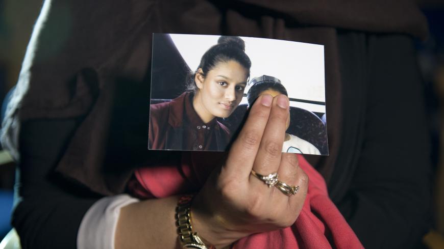 Renu, eldest sister of Shamima Begum holds her sister's photo whilst being interviewed by the media at New Scotland Yard, Central London. PRESS ASSOCIATION Photo. Picture date: Sunday February 22, 2015. See PA story  . Photo credit should read: Laura Lean/PA Wire