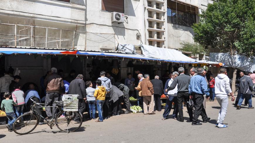 Syrians buy produce and foodstuffs at an open-air market in a street in the country's central and third largest city of Homs, on April 7, 2017. / AFP PHOTO / STRINGER        (Photo credit should read STRINGER/AFP via Getty Images)