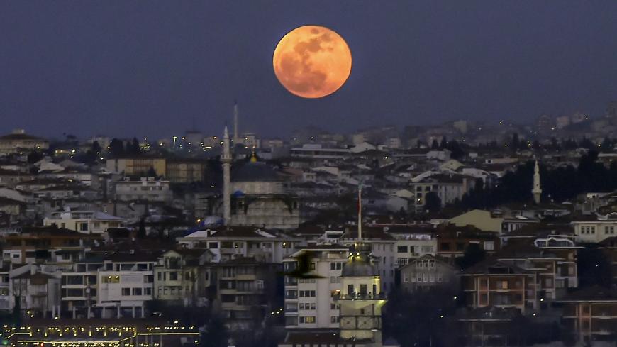 A picture taken on January 31, 2018 shows the moon during a lunar eclipse, referred to as the "super blue blood moon" up in the sky above the Bosphorus straits in Istanbul. - Skywatchers were hoping for a rare lunar eclipse that combines three unusual events -- a blue moon, a super moon and a total eclipse -- which was to make for a large crimson moon viewable in many corners of the globe. (Photo by YASIN AKGUL / AFP)        (Photo credit should read YASIN AKGUL/AFP via Getty Images)