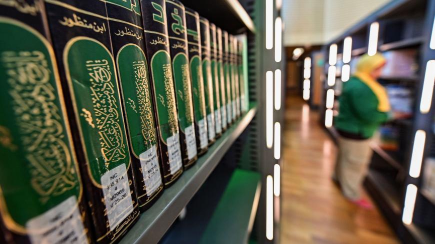 A photo taken on June 24, 2019 shows a stack of books as part of the collection of the "History of Damascus" summary volumes by the medieval Sunni Muslim scholar Ibn Asakir, on a shelf in the main building of the Bibliotheca Alexandrina library in Egypt's northern coastal city of Alexandria. - The Bibliotheca, established in 2002, serves as a modern-day commemoration of the Library of Alexandria of antiquity, and a modern-day public library and educational centre. (Photo by GIUSEPPE CACACE / AFP)        (Ph