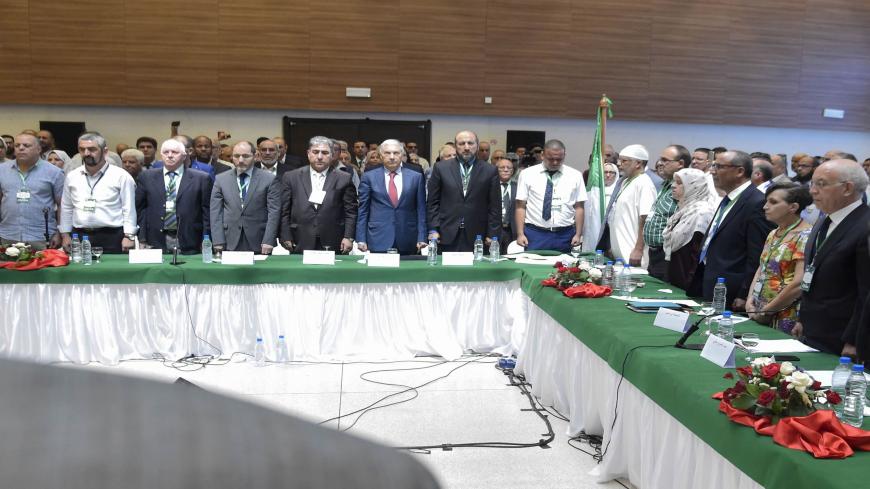 This picture taken on July 6, 2019 shows former Algerian prime minister Ali Benflis (2nd-R) and the president of the Algerian Islamist party the "Movement for the Society of Peace" Abderrazak Makri (C), attending with other members of political parties, civil society representatives and national personalities a meeting dubbed the "National Forum for Dialogue", at a hall at the School of Hotel and Restaurant Management in the capital Algiers' suburb of Ain Benian. - The meeting is being held outside the orbi