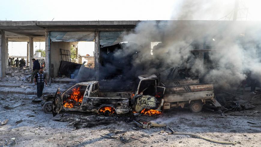 TOPSHOT - This picture taken on November 23, 2019 shows the aftermath of a car bomb explosion at the industrial zone in the northern Syrian town of Tal Abyad, on the border with Turkey. - Several people were killed, including civilians, over a dozen injured by the blast in the Turkish-controlled northern Syrian town. Turkey and its Syrian proxies control several pockets of territory on the Syrian side of the border as a result of successive incursions in 2016-17, 2018 and 2019. (Photo by Zein Al RIFAI / AFP