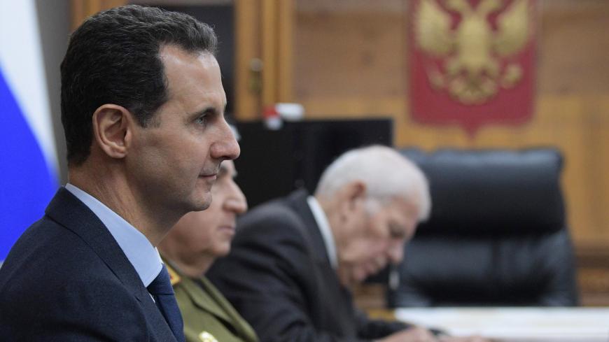 Syrian President Bashar al-Assad meets with his Russian counterpart at the headquarters of the Russian forces in the Syrian capital Damascus on January 7, 2020. - Putin met his Syrian counterpart Bashar al-Assad during an unprecedented visit to Damascus as the prospect of war between Iran and the United States loomed over the region. (Photo by Alexei Druzhinin / SPUTNIK / AFP) (Photo by ALEXEI DRUZHININ/SPUTNIK/AFP via Getty Images)