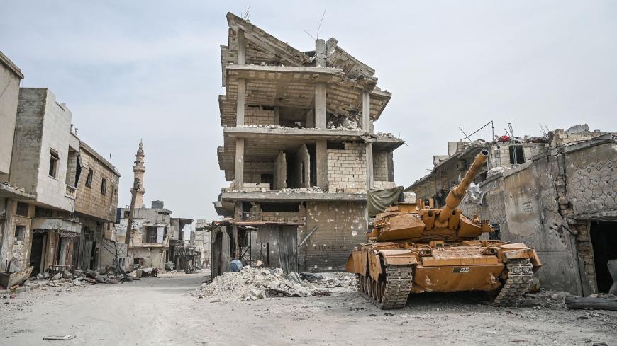A Turkish military tank is seen in a destroyed neighbourhood of Sarmin town, about eight kilometres southeast of the city of Idlib in northwestern Syria, on March 10, 2020. - When protesters in March 2011 demanded their rights and regime change, they likely never imagined it would trigger a reaction that has led to the 21st century's biggest war. Nine years on, President Bashar al-Assad is still in power and there to stay, more than 380,000 people have died, dozens of towns and cities razed to the ground an