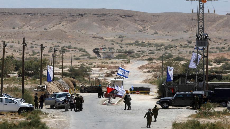 Israeli soldiers gather at the crossing checkpoint on the Israeli-Jordanian border near Moshav Tsofar in the Arava valley, south of the Dead Sea basin, on April 30, 2020. - Israeli farmers will no longer be allowed to enter an agricultural enclave in neighbouring Jordan, following the expiry of Israels lease on the border land. (Photo by MENAHEM KAHANA / AFP) (Photo by MENAHEM KAHANA/AFP via Getty Images)