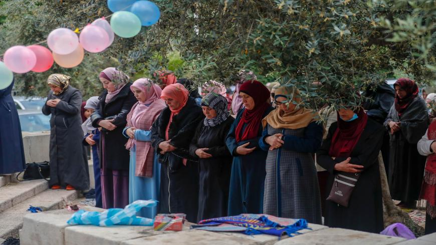 Palestinian women worshippers gather to attend the prayers of Eid al-Fitr, the Muslim holiday which starts at the conclusion of the holy fasting month of Ramadan, outside the closed Aqsa mosque complex in Jerusalem's old city early on May 24, 2020. - Muslims around the world began marking a sombre Eid al-Fitr, many under coronavirus lockdown, but lax restrictions offer respite to worshippers in some countries despite fears of skyrocketing infections. Jerusalem's Al-Aqsa mosque, Islam's third holiest site, w