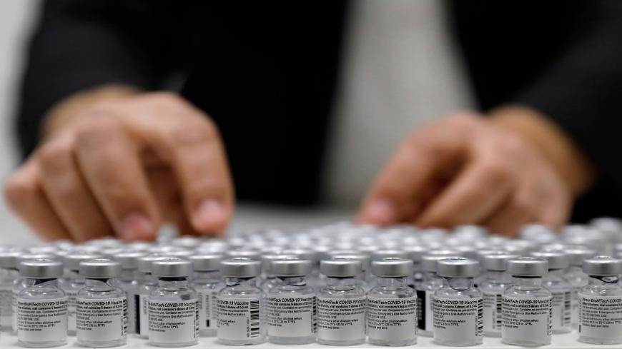 A health worker arranges vials of the Pfizer-BioNtech COVID-19 vaccine at the Clalit Health Services in the Palestinian neighbourhood of Beit Hanina, in the Israeli-annexed east Jerusalem on March 2, 2021. (Photo by AHMAD GHARABLI / AFP) / The erroneous mention[s] appearing in the metadata of this photo by AHMAD GHARABLI has been modified in AFP systems in the following manner: [March 2] instead of [March 3]. Please immediately remove the erroneous mention from all your online services and delete it from yo