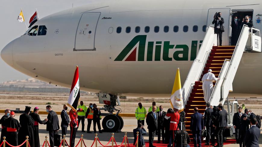 Pope Francis climbs the stairs to board his Alitalia Airbus A330 aircraft as he departs from the Iraqi capital's Baghdad International Airport on March 8, 2021. (Photo by Ahmad AL-RUBAYE / AFP) (Photo by AHMAD AL-RUBAYE/AFP via Getty Images)