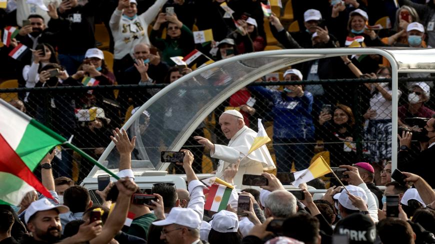 ERBIL, IRAQ - MARCH 07: (EDITORS NOTE: Transmitted with alternate crop) Pope Francis waves to the crowd as he arrives to conduct mass at the  Franso Hariri Stadium on March 07, 2021 in Erbil, Iraq. Pope Francis arrived in Erbil, the final stop of his historic four-day visit, the first-ever papal visit to Iraq. In his first foreign trip since the start of the pandemic, Pope Francis visited Baghdad, Najaf, Erbil, and the cities of Qaraqosh and Mosul, which were heavily destroyed by ISIS. Although the trip is 