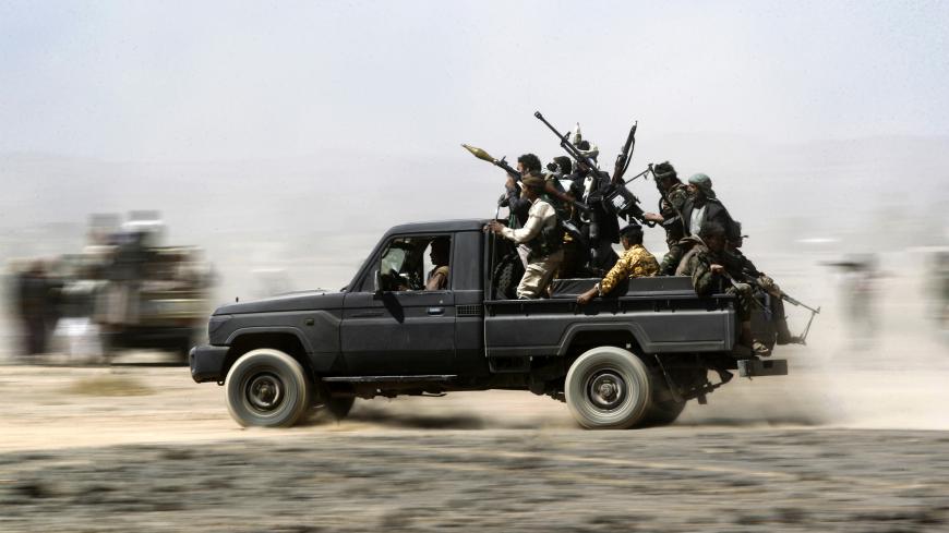TOPSHOT - Armed Yemeni tribesmen loyal to the Shiite Huthi rebels sit in the back of an armed vehicle during a gathering to mobilise more fighters into several battlefronts on November 1, 2016 on the outskirts of the capital Sanaa. 
The war in Yemen escalated in March 2015 when the Saudi-led coalition launched a military campaign to push back the Huthi rebels, after they seized the capital in 2014 and then advanced on other parts of Yemen. 

 / AFP / MOHAMMED HUWAIS        (Photo credit should read MOHAMMED