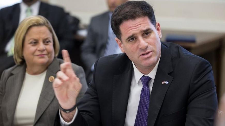 Israeli Ambassador to the United States Ron Dermer (R) speaks to members of Congress about Israel's ongoing air campaign against Hamas for missile attacks during a meeting on Capitol Hill in Washington July 11, 2014.  REUTERS/Joshua Roberts    (UNITED STATES - Tags: POLITICS) - RTR3Y6P1