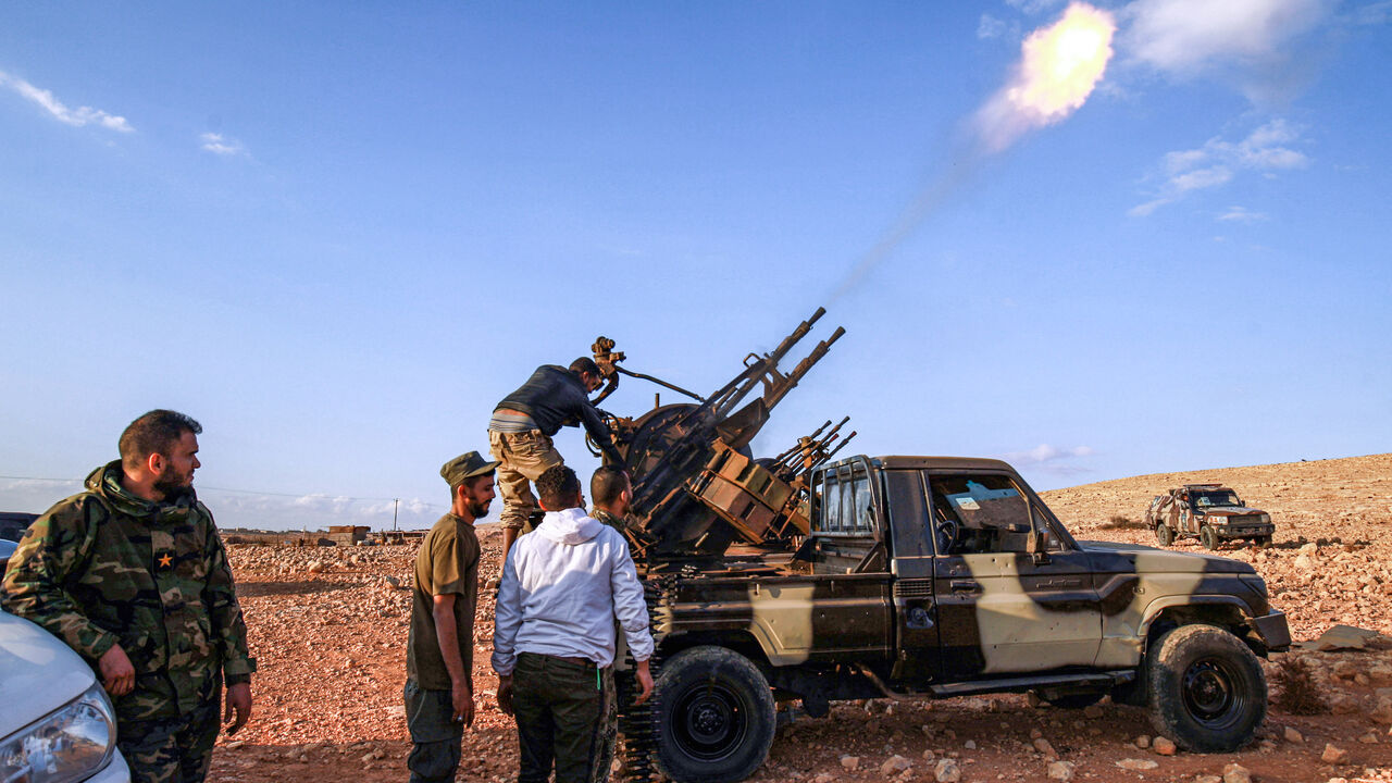 An anti-aircraft gun fires rounds in tribute during the funeral of General Wanis Bukhamada, commander of the "Saiqa" (Special Forces) of the self-proclaimed Libyan National Army (LNA) loyal to strongman Khalifa Haftar, in the eastern city of Benghazi on Nov. 1, 2020. 