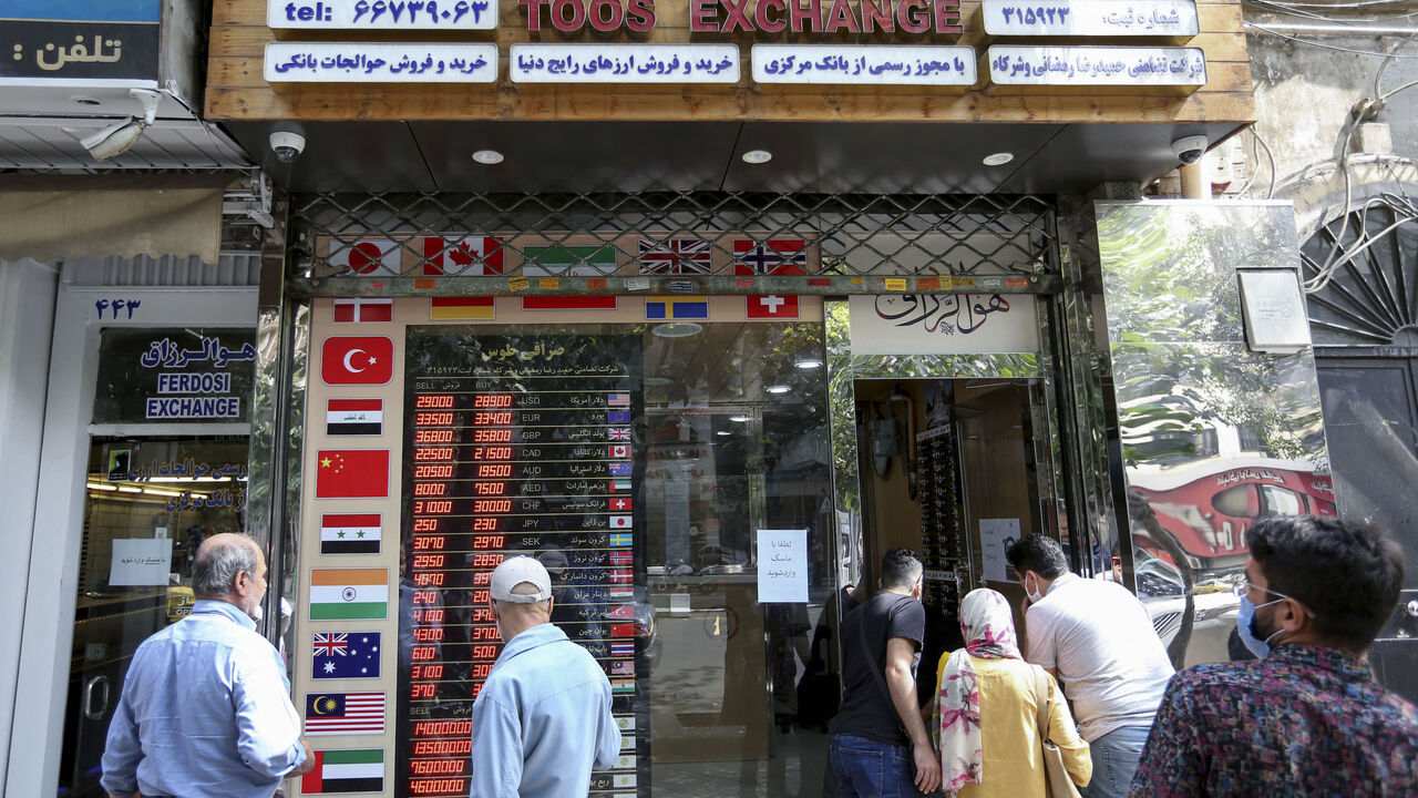 Iranians check a display board at a currency exchange shop in the capital Tehran, on Sept. 29, 2020. For Iran, struggling from sanctions imposed under Washington's policy of "maximum pressure", the US presidential race raised hope of change — but also fears that life could get even worse.