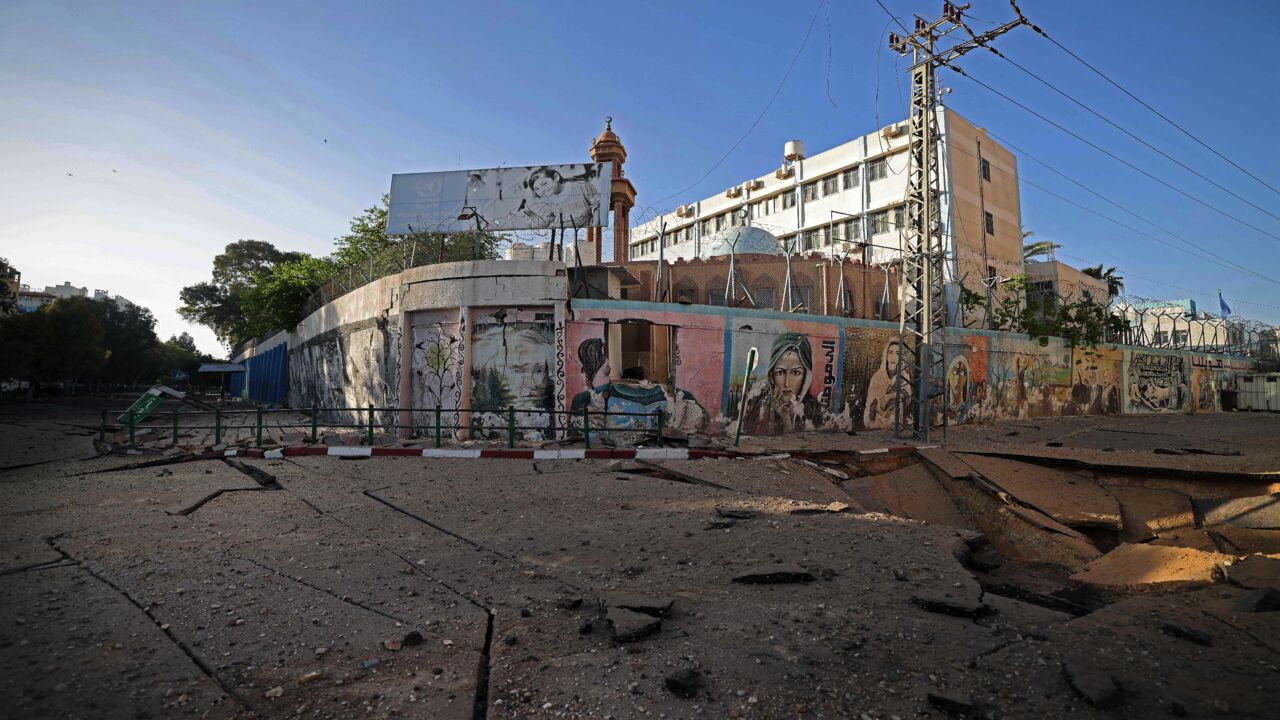 A picture taken early on May 12, 2021, shows a huge crater in the main street in Gaza City, following Israeli airstrikes on the Hamas-run territory overnight. Israeli air raids in the Gaza Strip have hit the homes of high-ranking members of the Hamas militant group, the military said Wednesday, with the territory's police headquarters also targeted. 