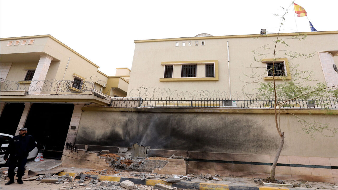 Libyan police stand guard outside the Spanish Embassy in Tripoli after a bomb exploded outside the building during the night without causing injurues, April 21, 2015.