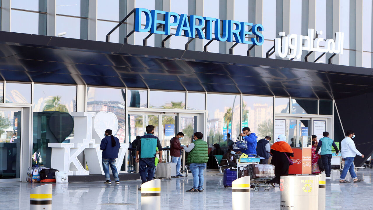 Passengers wait at the departure gate at Kuwait international airport, after a 12-day closure to stem the spread of the coronavirus pandemic, Kuwait City, Kuwait, Jan. 3, 2021.