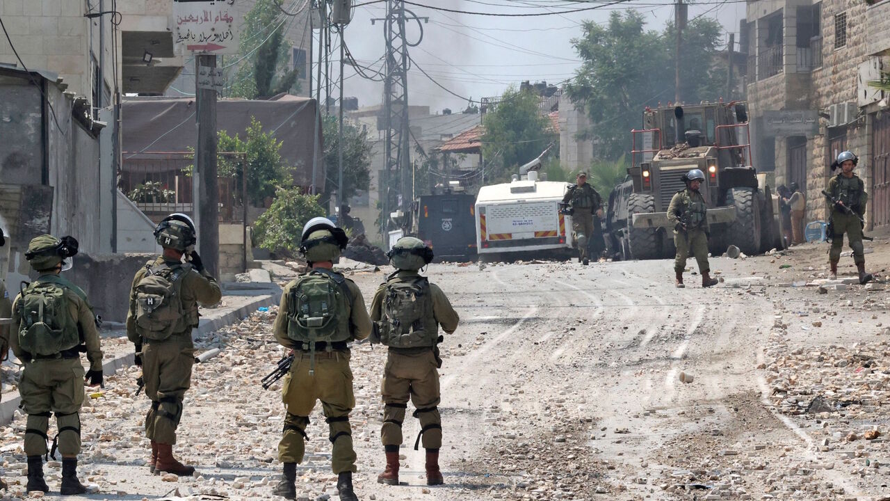 Palestinian protestors clash with Israeli forces the funeral of a 20-year-old Palestinian, in the village of Beit Ummar, north of the West Bank City of Hebron, on July 30, 2021.