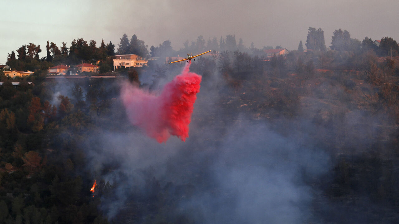 A firefighting plane works on extinguishing a forest fire at the Jerusalem mountains near Shoresh, on Aug. 16, 2021.