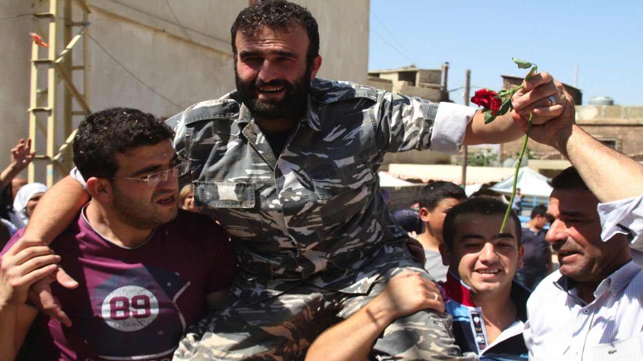 Saleh al-Baradei, a Lebanese police officer kidnapped along with four soldiers by Jabhat al-Nusra, the Syrian branch of al-Qaeda, celebrates with relatives after his release on Aug. 31, 2014.