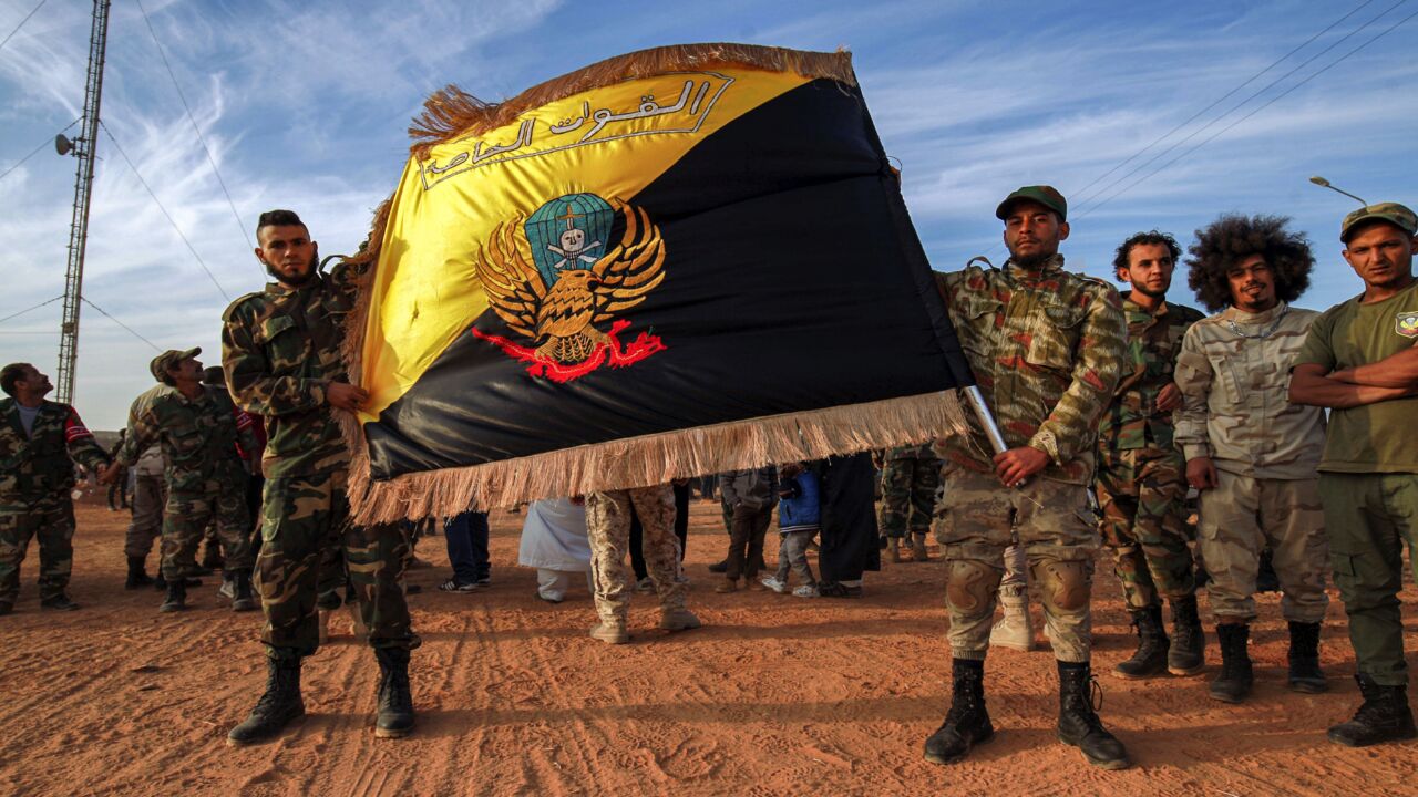 Members of the special forces of the self-proclaimed Libyan National Army, loyal to eastern strongman Khalifa Hifter, pose with their flag in the eastern city of Benghazi on Nov. 6, 2020.