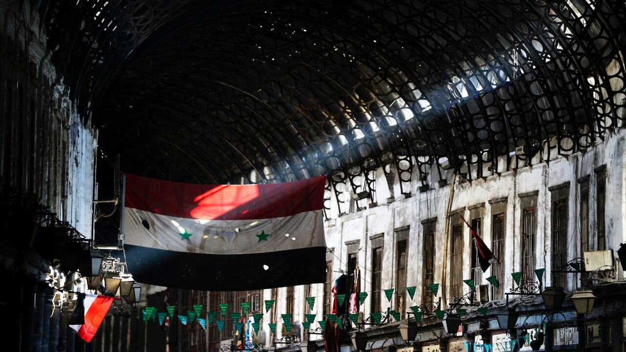 A general view shows the Syrian flag flying at the Hamidiya market in the old part of Damascus on Nov. 2, 2017.