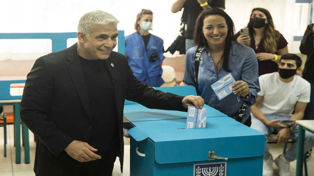 Yesh Atid party leader Yair Lapid and his wife Lihi Lapid cast their vote as Israelis head to the poll, Tel Aviv, Israel, March 23, 2021.