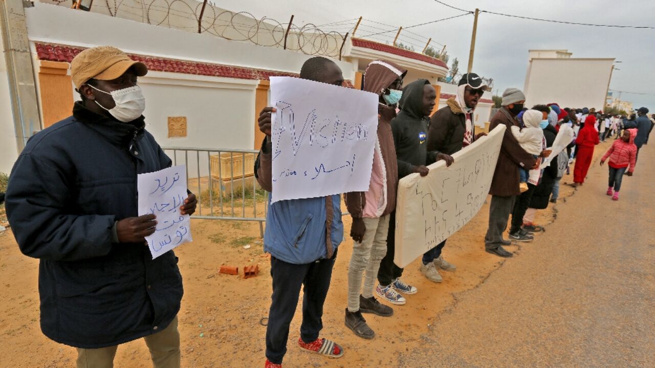 African migrants are pictured at a United Nations High Commissioner for Refugees (UNHCR) camp in the southern Tunisian port of Zarzis, near the Libyan border, during a protest demanding their resettlement, on February 14, 2022 