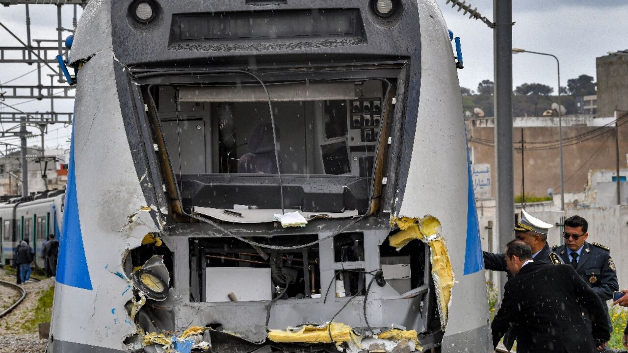 Police inspect the damage to one of the locomotives in a train collision in the Jbel Jelloud area in the south of Tunisia's capital Tunis on March 21, 2022
