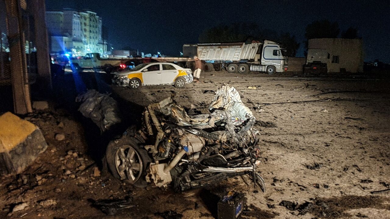 Burnt-out shell of a destroyed car lies in the area where a senior army officer was among five Yemeni soldiers killed in a bomb attack near the southern city of Aden