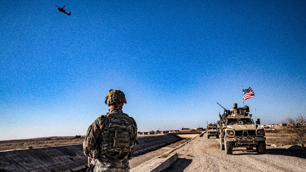 US soldiers patrol between areas held by the Syrian Kurdish forces and Turkish-backed fighters in northeastern Syria in December 2021