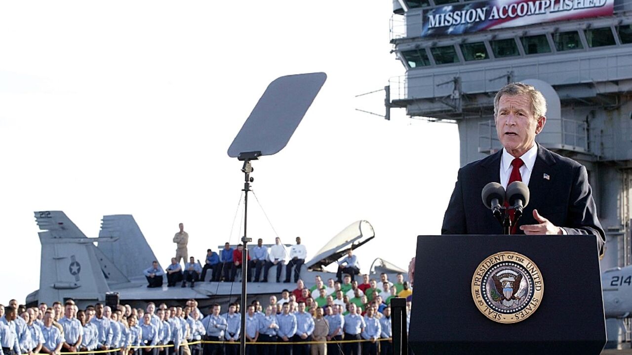 US President George W. Bush addresses his nation aboard the aircraft carrier USS Abraham Lincoln in the Gulf on May 1, 2003, in front of a banner reading "Mission Accomplished" --  a claim belied by years more of hard fighting in Iraq