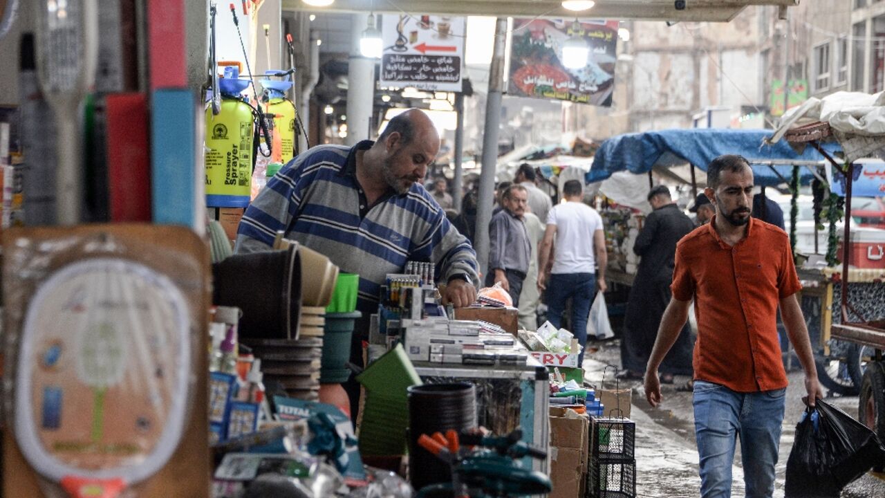 An Iraqi vendor organises his stall in Mosul, part of Nineveh province where unemployment is around 40 percent