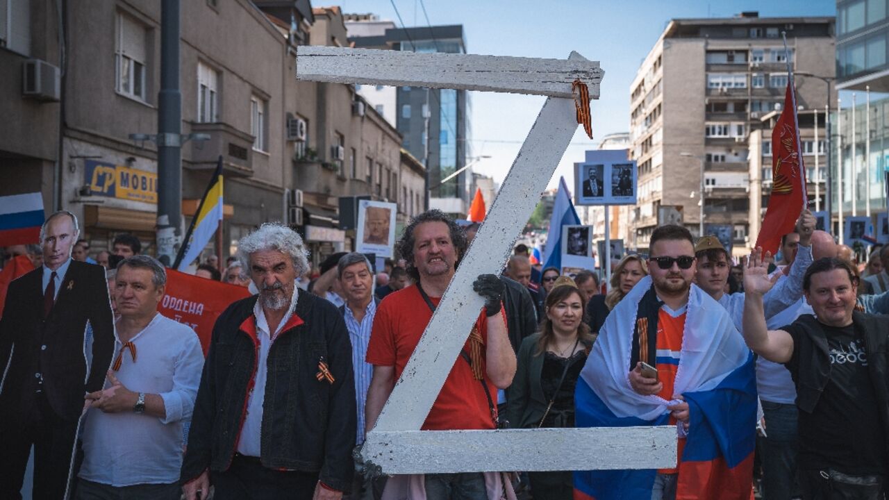 A man at the Belgrade march carried a large letter 'Z', the mark of Russia's invasion of Ukraine