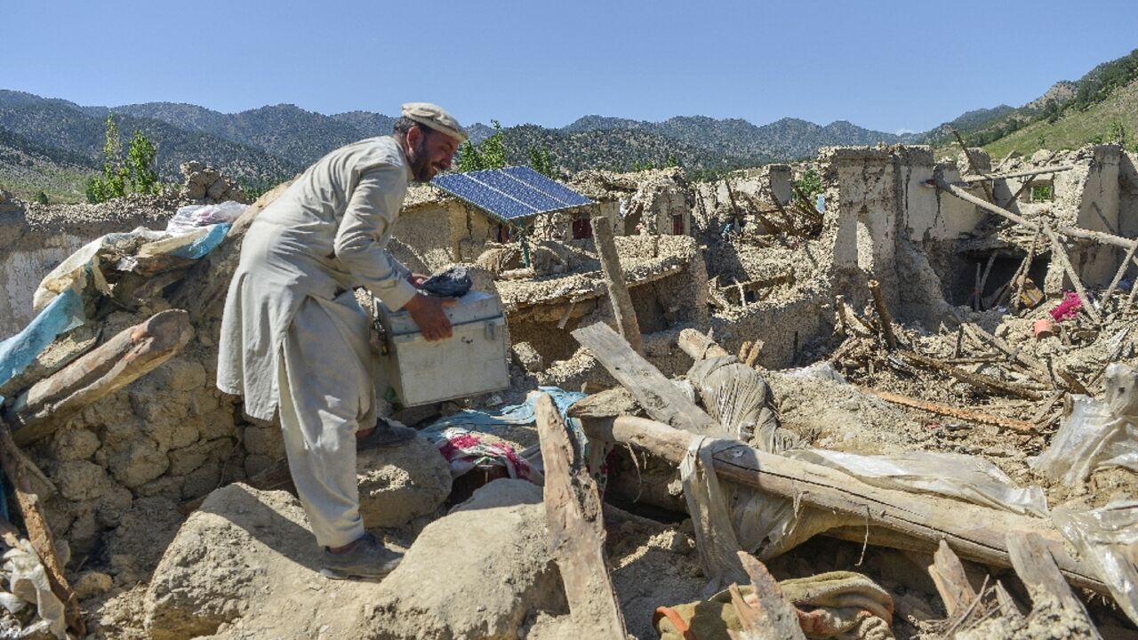 A villager searches for valuables in the ruins of his home at Wuchkai, just 10 kilometres (6 miles) from the epicentre of the deadly Afghan quake