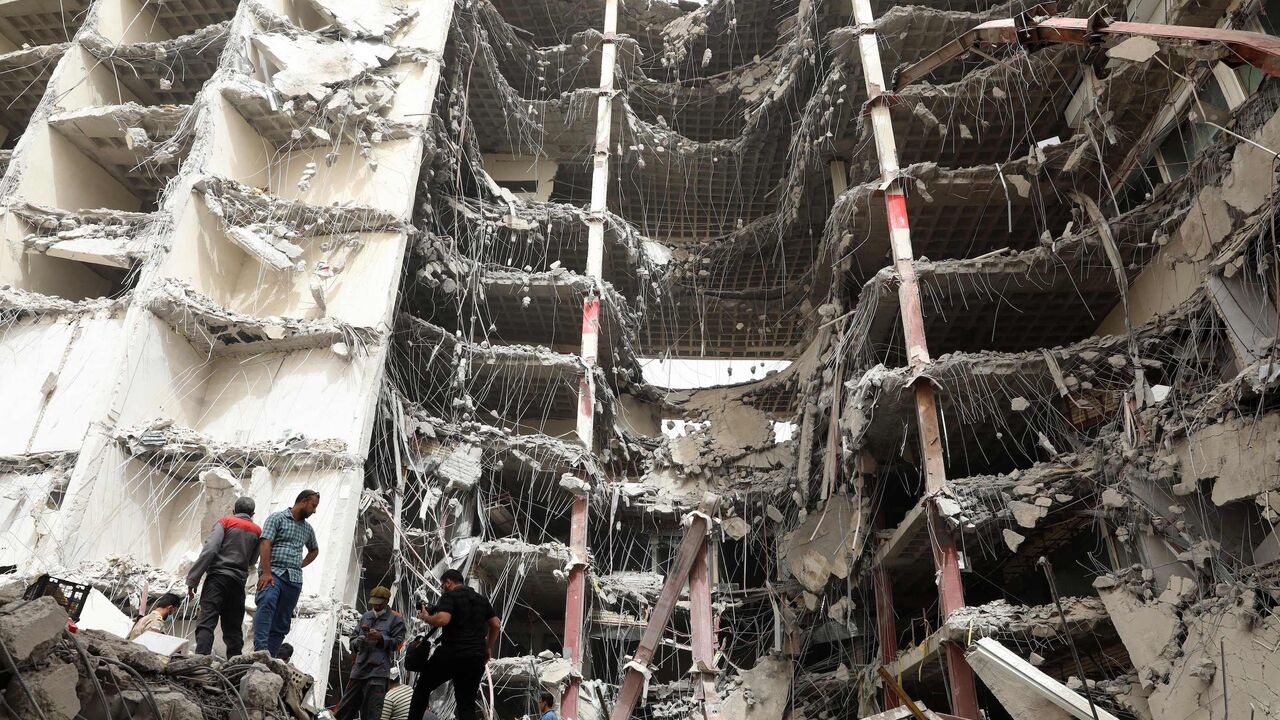 Iranians gather at the site where a 10-story building collapsed.