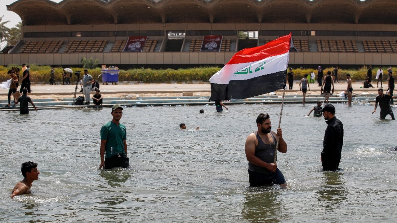 Supporters of Iraqi cleric Moqtada Sadr cool off in Baghdad's Green Zone, where they continue to protest a rival Shiite faction's nomination for prime minister