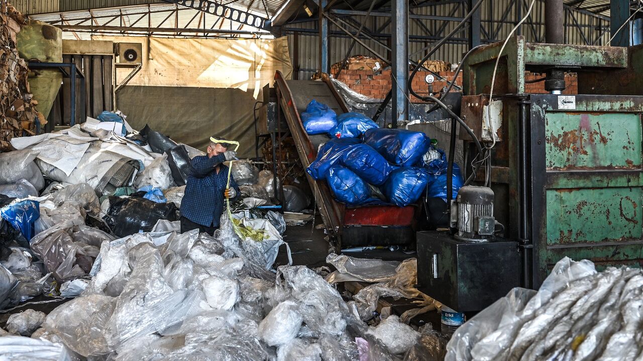 A worker sorts out plastic waste collected at a plastic recycling factory in Kartepe, district of Kocaelion, Turkey, May 11, 2022.