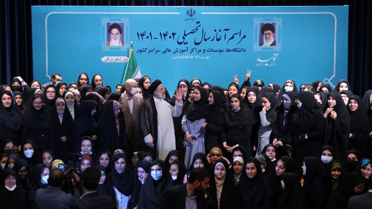 Iran's ultraconservative President Ebrahim Raisi poses for a group photograph with female students at Tehran's Al-Zahra university at the start of the new academic year